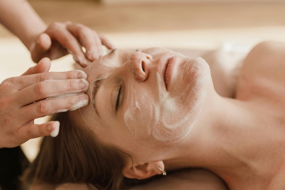 Woman in a spa having a cleansing facial