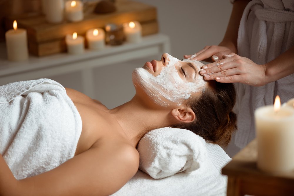 woman at a spa having a facial applied